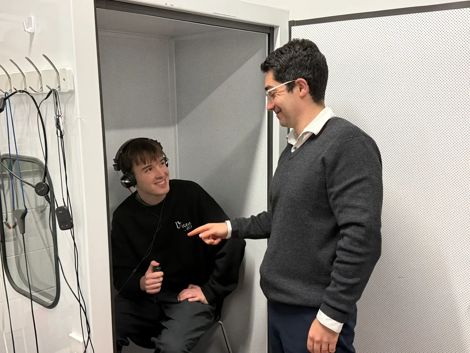 Lachlan Smith fitting a hearing aid for a patient